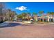 Brick-paved town center featuring a fountain and lined with palm trees and various retail buildings at 5238 Baskin St, Orlando, FL 32814