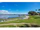 Scenic waterfront view featuring a gazebo, lush green space, and a calm lake under a blue sky at 5238 Baskin St, Orlando, FL 32814