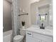 A well-lit bathroom features a tub with shower and a white vanity with quartz countertop at 6312 Dew Drop Loop, St Cloud, FL 34771