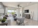 This bright living room features neutral walls, modern furnishings, and a backyard view at 6312 Dew Drop Loop, St Cloud, FL 34771