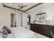 Well-lit main bedroom with a modern light fixture, a dresser, and ensuite bathroom access at 6312 Dew Drop Loop, St Cloud, FL 34771