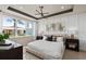 Relaxing main bedroom with tray ceilings, a large window and modern decor at 6312 Dew Drop Loop, St Cloud, FL 34771