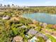 Scenic aerial shot showcasing luxurious homes, a tranquil lake, and lush greenery at 724 Lake Davis Dr, Orlando, FL 32806