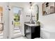 Bathroom featuring dark cabinetry, modern mirror, and backyard access at 724 Lake Davis Dr, Orlando, FL 32806