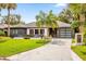 Charming exterior view of a single-story home with modern garage door and landscaped yard at 724 Lake Davis Dr, Orlando, FL 32806