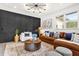 Inviting living room with stylish black accent wall, modern furniture and area rug at 724 Lake Davis Dr, Orlando, FL 32806