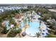 Aerial view of a resort-style pool and lazy river surrounded by palm trees and lounge chairs at 7838 Spectrum Dr, Kissimmee, FL 34747