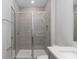 Bathroom features a tiled shower with glass doors and a white quartz countertop at 7838 Spectrum Dr, Kissimmee, FL 34747