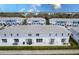 An aerial view shows townhomes with patios perfect for outdoor dining in a vibrant community at 7838 Spectrum Dr, Kissimmee, FL 34747