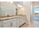 Bright bathroom showcasing a double vanity with granite countertop and a view to a bedroom at 889 Megano Blvd, Deland, FL 32724