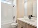 Modern bathroom featuring white subway tile, a bathtub, and a stylish vanity with black fixtures at 889 Megano Blvd, Deland, FL 32724