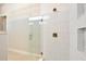 Shower with glass door and ceramic tile, built-in shelves, and a brushed metal shower head at 889 Megano Blvd, Deland, FL 32724