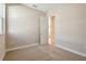 Cozy bedroom with neutral walls, a window and access to another room through an open door at 889 Megano Blvd, Deland, FL 32724