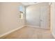 Neutral bedroom with a window and an open door showing another room at 889 Megano Blvd, Deland, FL 32724