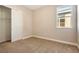 Neutral bedroom featuring a window and a closet with a door ajar at 889 Megano Blvd, Deland, FL 32724