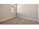 Bright and simple bedroom featuring a window and neutral walls and carpet at 889 Megano Blvd, Deland, FL 32724