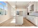 Bright open-concept kitchen with granite island, stainless appliances, and sleek white cabinets at 889 Megano Blvd, Deland, FL 32724