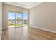 Bright living room with wood floors and sliding glass door with an open view to the backyard at 889 Megano Blvd, Deland, FL 32724