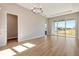 Bright living room featuring wood floors, recessed lighting, and a sliding door overlooking the backyard at 889 Megano Blvd, Deland, FL 32724