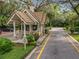 Charming community entrance with a guard house, well-maintained landscaping, and a secure entry point at 102 Tomoka Trl # 102, Longwood, FL 32779