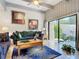 Cozy living room features neutral paint, ceiling fan, and sliding glass doors that let in natural light at 102 Tomoka Trl # 102, Longwood, FL 32779