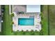 Aerial view of a backyard with a pool, patio, and palm trees at 10236 Chorlton Cir, Orlando, FL 32832