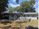 The backyard features a concrete patio, complemented by ample foliage and natural light at 103 Brown Dr, Sanford, FL 32773