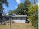 The backyard includes a concrete patio perfect for outdoor relaxation and entertaining with lush foliage at 103 Brown Dr, Sanford, FL 32773