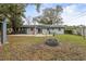 Spacious backyard featuring a concrete patio, fire pit, and lush greenery, ideal for outdoor entertaining at 103 Brown Dr, Sanford, FL 32773