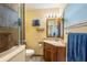Bathroom with vanity, granite countertop, wood cabinets, glass shower and blue towels at 103 Brown Dr, Sanford, FL 32773