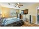 Bedroom with wood-look flooring, ceiling fan, mounted TV, and natural light at 103 Brown Dr, Sanford, FL 32773