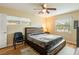 Bedroom featuring a wooden bed frame, ceiling fan, and natural light from the two windows at 103 Brown Dr, Sanford, FL 32773