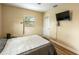 Bedroom with wood floors, ceiling fan, and a window for natural light at 103 Brown Dr, Sanford, FL 32773