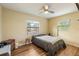 Bedroom with wood floors, ceiling fan, and two windows for natural light at 103 Brown Dr, Sanford, FL 32773