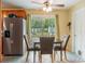 Eat-in kitchen features patio access, stainless refrigerator, and tile flooring at 103 Brown Dr, Sanford, FL 32773