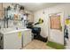 Laundry room features washer, dryer, storage shelves, and a door to the exterior at 103 Brown Dr, Sanford, FL 32773