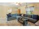 Cozy living room with a sectional couch, a ceiling projector, and ample natural light at 103 Brown Dr, Sanford, FL 32773