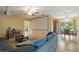 Spacious living room featuring a large screen, dining area and a comfortable blue sectional couch at 103 Brown Dr, Sanford, FL 32773