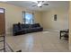 Living room boasting a large couch, tile floors, natural light from window, and neutral walls at 103 Brown Dr, Sanford, FL 32773