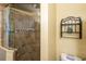 Bathroom boasting a tiled shower enclosure with glass door, complemented by neutral walls and fixtures at 103 Brown Dr, Sanford, FL 32773