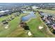 Aerial of golf course, lake, and residential homes in a planned community on a sunny day at 10912 Mobberley Cir, Orlando, FL 32832