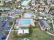 Community clubhouse and pool area with ample parking and green spaces at 10912 Mobberley Cir, Orlando, FL 32832