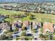 Aerial view of homes in a golf course community with a lake and lush landscaping at 10912 Mobberley Cir, Orlando, FL 32832