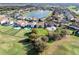Aerial view of a backyard outlined in red, with trees and golf course in the background at 10912 Mobberley Cir, Orlando, FL 32832
