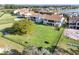Large grass backyard with a fence and mature trees bordering neighboring homes and a lake at 10912 Mobberley Cir, Orlando, FL 32832
