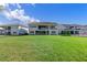 Wide shot of a very large, level, manicured lawn area and the rear of the home at 10912 Mobberley Cir, Orlando, FL 32832