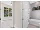 Bathroom with neutral colored tile, tub-shower combo, and a window providing natural light at 10912 Mobberley Cir, Orlando, FL 32832