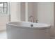 Close up of bathroom's soaking tub with brushed-nickel faucet fixtures at 10912 Mobberley Cir, Orlando, FL 32832