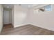 Bright, airy bedroom featuring wood floors, a large window, and neutral paint, creating a serene living space at 10912 Mobberley Cir, Orlando, FL 32832