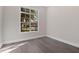 Bright, empty bedroom with hardwood floors, a large window, and neutral walls at 10912 Mobberley Cir, Orlando, FL 32832